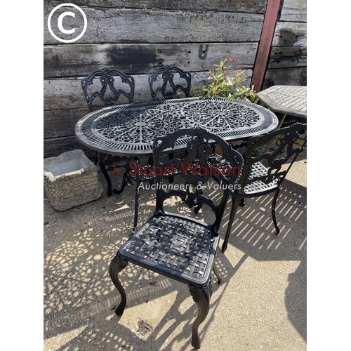475 - A black painted ornate aluminium garden table with four matching chairs