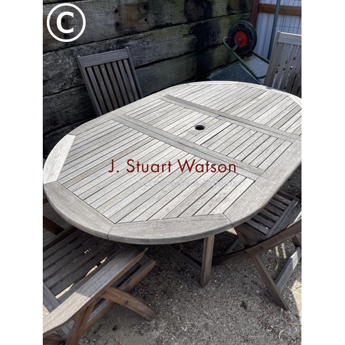 476 - A solid hardwood garden table together with two carvers and two standard  chairs