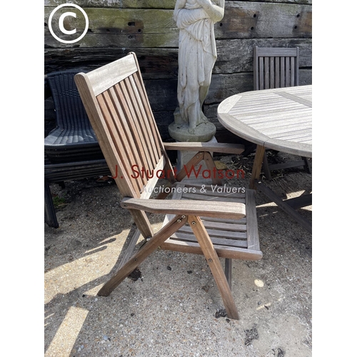 476 - A solid hardwood garden table together with two carvers and two standard  chairs
