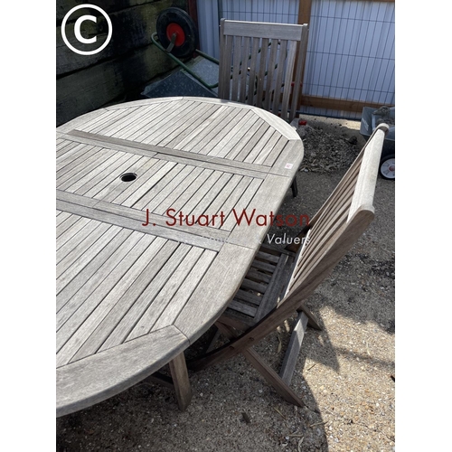 476 - A solid hardwood garden table together with two carvers and two standard  chairs