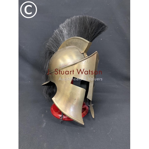 512 - Trojan/Gladiator brass helmet wooden stand, height 48cms