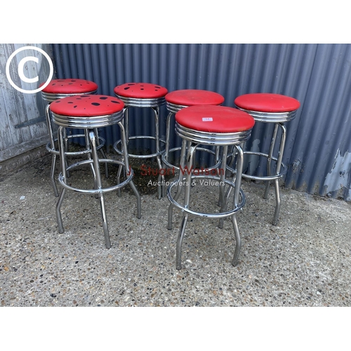 54 - A set of six chrome stools with red vinyl seats