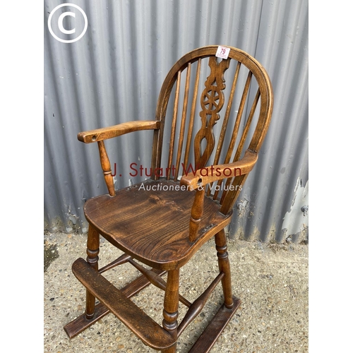 79 - An antique oak child's wheel back high chair