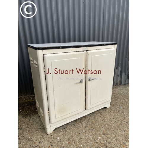 8 - A vintage metal kitchen cupboard with enamel top