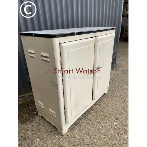 8 - A vintage metal kitchen cupboard with enamel top