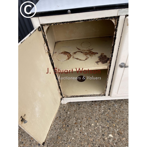 8 - A vintage metal kitchen cupboard with enamel top