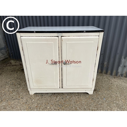 8 - A vintage metal kitchen cupboard with enamel top