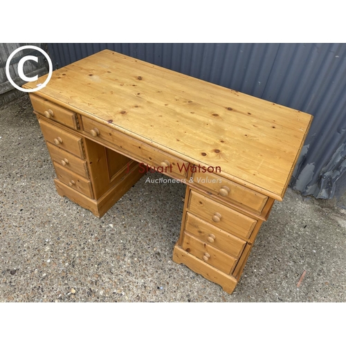 88 - A farmhouse style pine pedestal desk