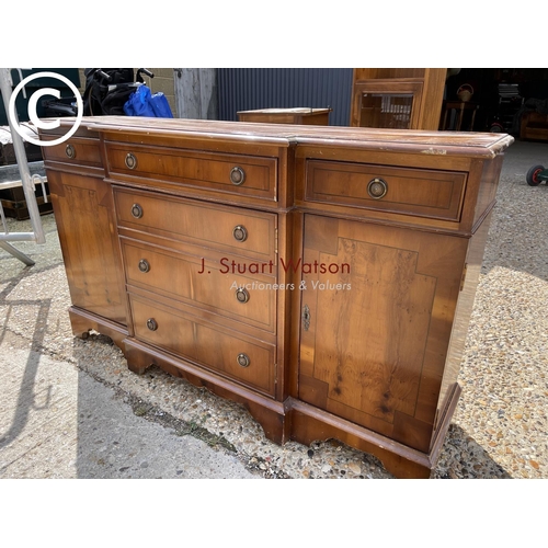 93 - A small yew wood break front sideboard