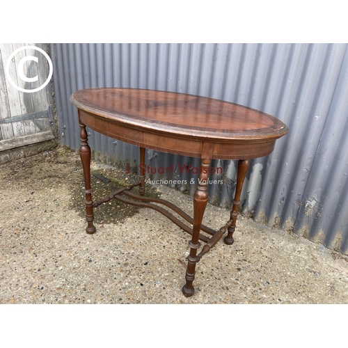 296 - An oval inlaid mahogany centre table