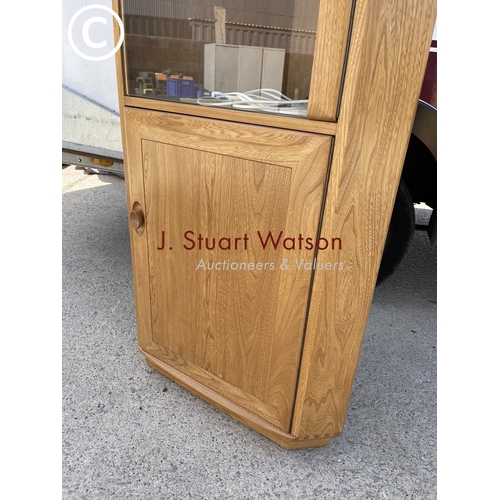 368 - A modern Ercol light elm corner display cabinet with illuminating interior