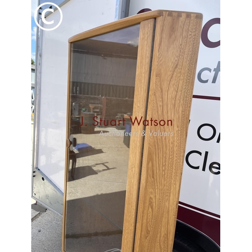 368 - A modern Ercol light elm corner display cabinet with illuminating interior