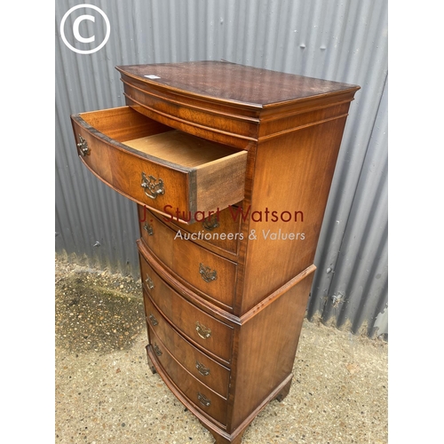 100 - A reproduction mahogany tallboy chest of six drawers with a bow front