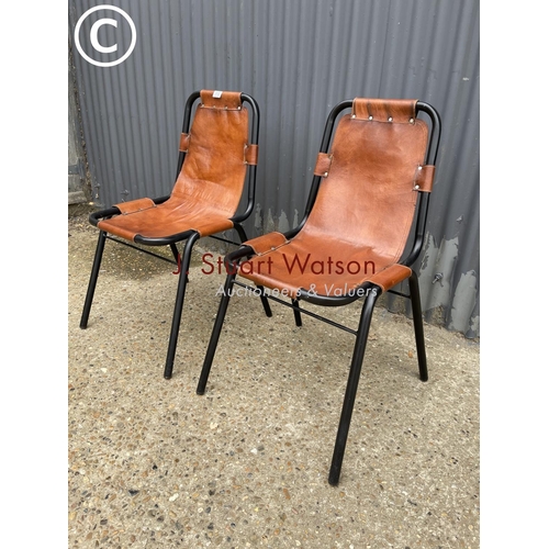 113 - A pair of metal framed stacking chairs with brown leather seats