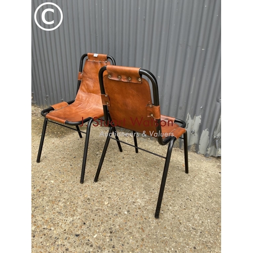 113 - A pair of metal framed stacking chairs with brown leather seats