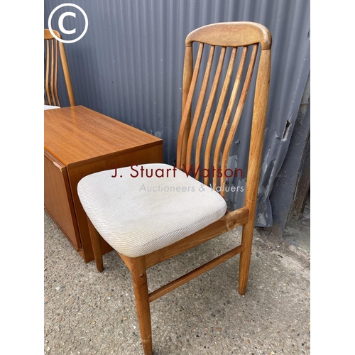 121 - A small teak sideboard together with two danish style teak chairs