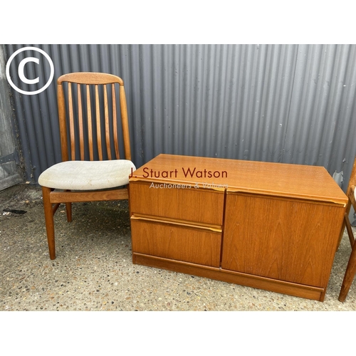 121 - A small teak sideboard together with two danish style teak chairs