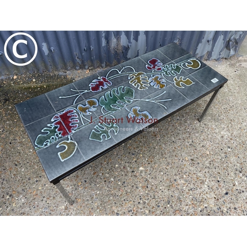 123 - A mid century tile top coffee table on chrome legs