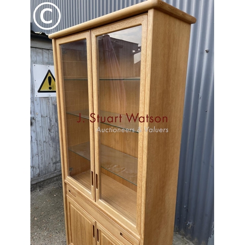 124 - A teak glazed bookcase cabinet with drawer