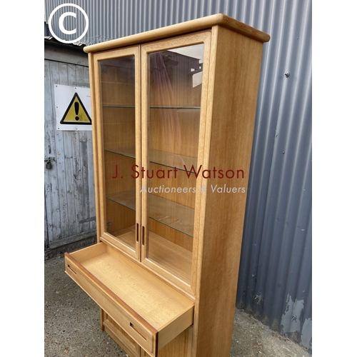 124 - A teak glazed bookcase cabinet with drawer