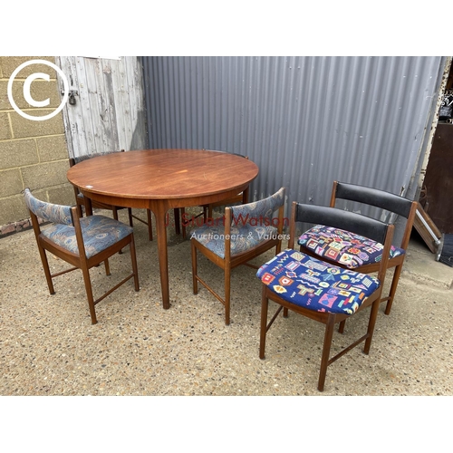 138 - A mcintosh teak circular extending dining table together with six matching Macintosh chairs