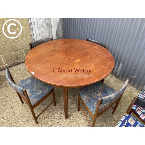 138 - A mcintosh teak circular extending dining table together with six matching Macintosh chairs