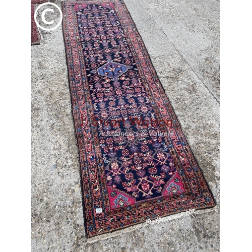 150 - A long red oriental pattern runner rug 320x94