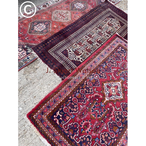 153 - Three blue and red oriental pattern rugs including one runner