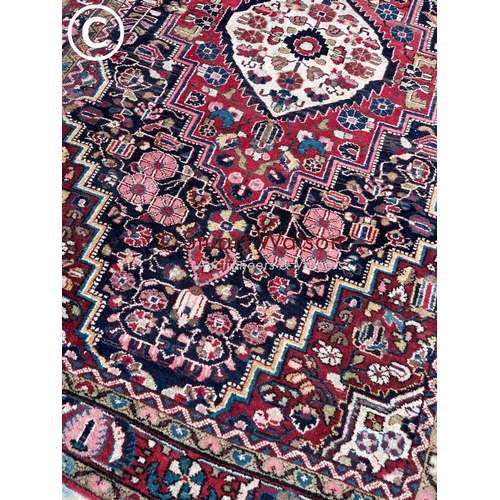 154 - An oriental red pattern rug