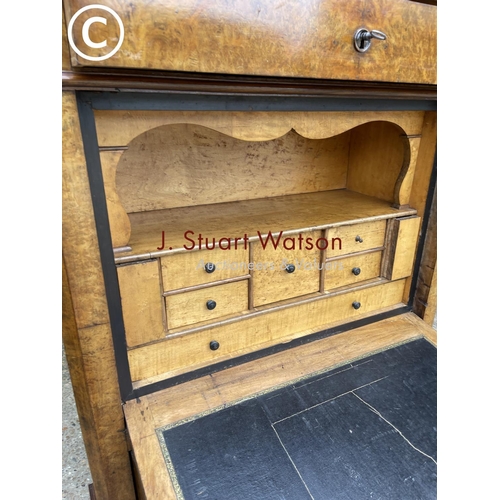 193 - A continental walnut escritoire cabinet with fall front revealing a  fitted interior, drawers to low... 