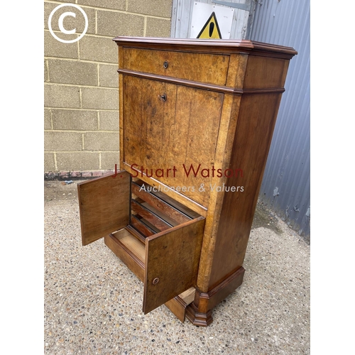 193 - A continental walnut escritoire cabinet with fall front revealing a  fitted interior, drawers to low... 