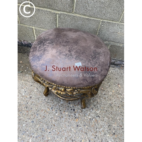 200 - A gold gilt circular stool / seat with brown leather top