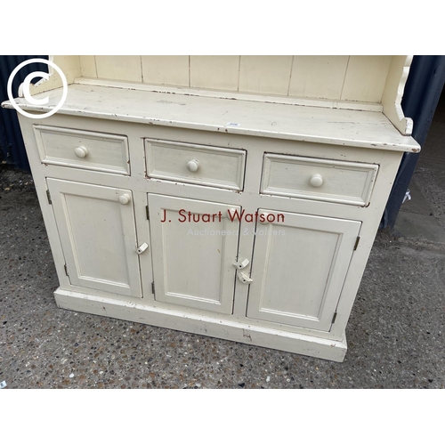 226 - A painted pine dresser with three plate rack top over three drawers and three cupboard base