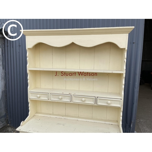 226 - A painted pine dresser with three plate rack top over three drawers and three cupboard base