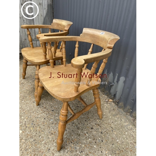 228 - A pair of pine smokers bow back chairs