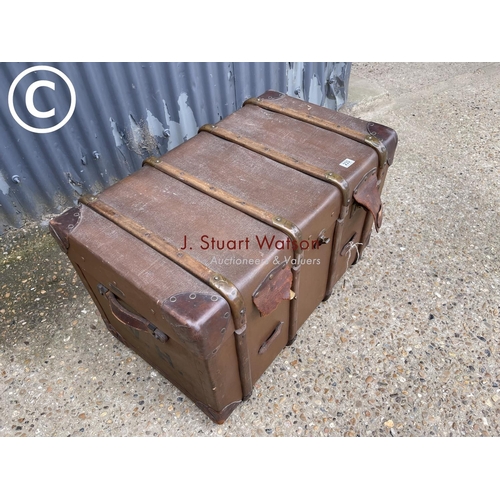 233 - A large vintage brown trunk fitted with two trays to the interior