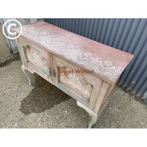 255 - A pink painted oak two door sideboard 123x 45 x 94