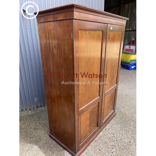 261 - A Victorian mahogany two door wardrobe with four section doors (feet detached) 122x60x183