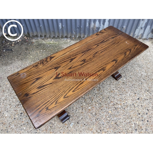 282 - A reproduction oak refectory style coffee table