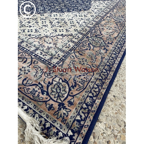 293 - A large blue silky pattern rug 195x 300 together with a modern rust colour rug