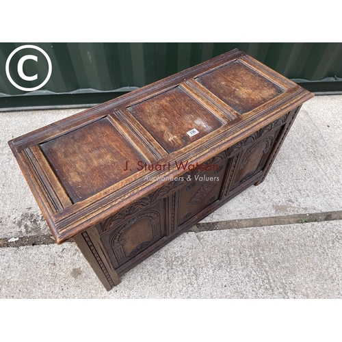 336 - A carved oak three panel blanket box chest