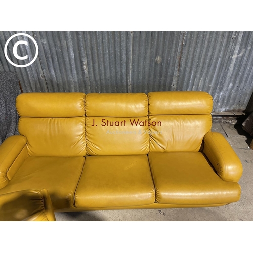 63 - A mid 20th century mustard coloured vinyl three piece lounge suite