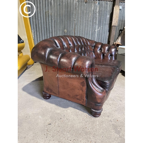 64 - A brown leather chesterfield style two seater sofa