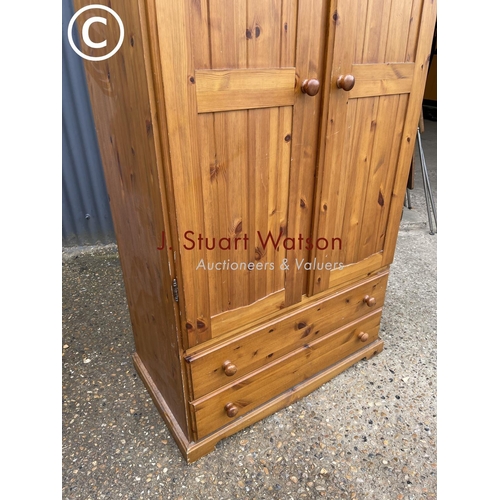 69 - A solid pine double wardrobe with drawers