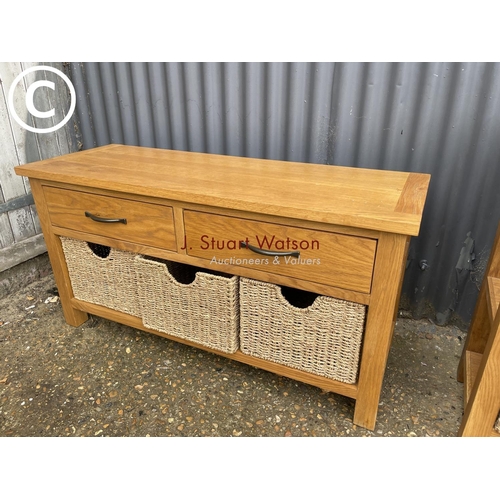 71 - Two matching light oak lounge tables with drawers and basket storage