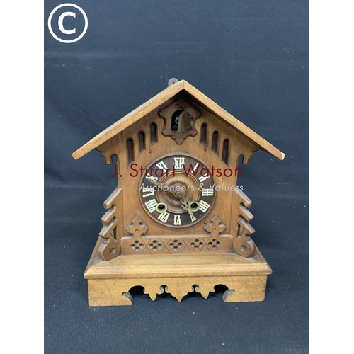 718 - Wooden cuckoo clock and key, height 30cms,