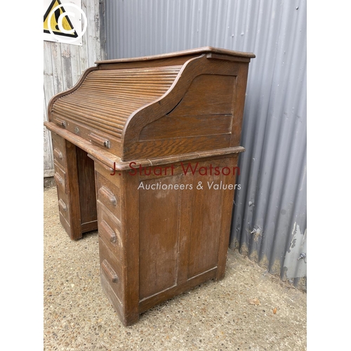 87 - An early 20th century oak roll top desk