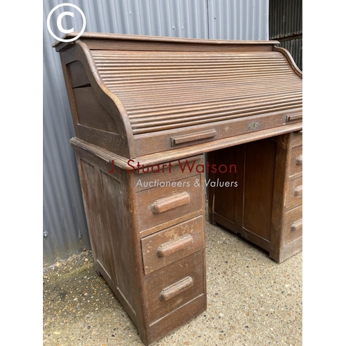 87 - An early 20th century oak roll top desk