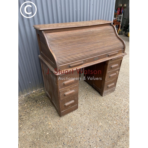 87 - An early 20th century oak roll top desk