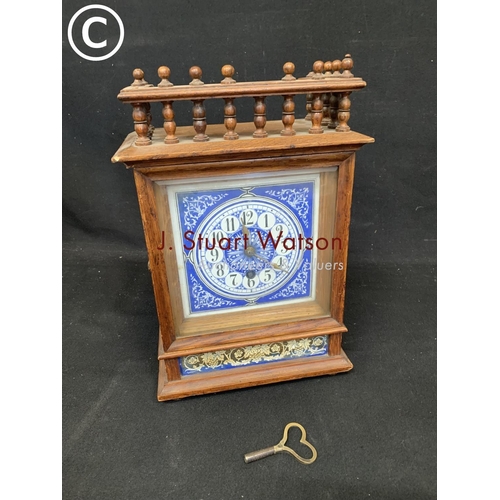 910 - Oak cased Aesthetic style mantel clock with blue and white enamel dial and panel,  height 34 cms